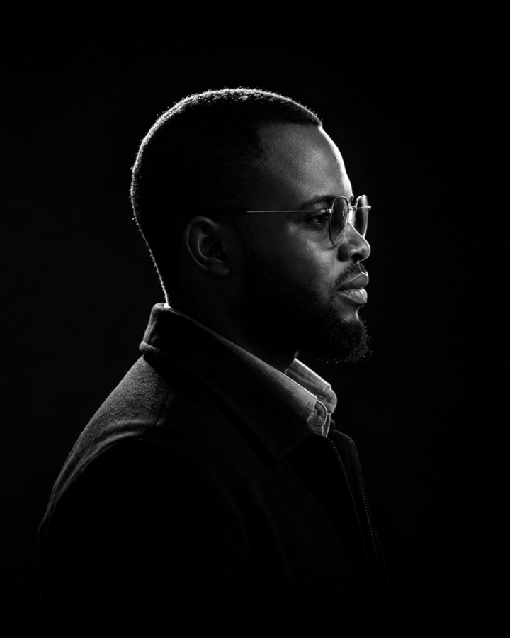 Moses Oyebamiji, black and white profile portrait